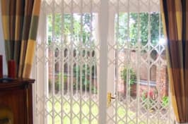 white retractable security grilles
